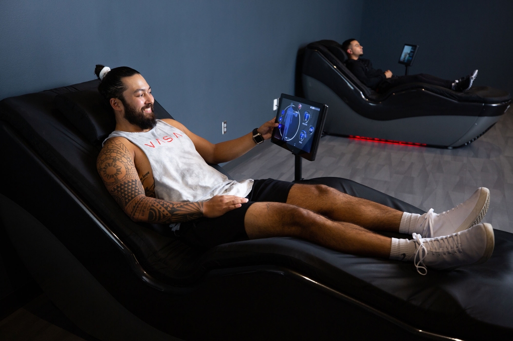 Happy relaxed man using Hydro massager at VASA Fitness