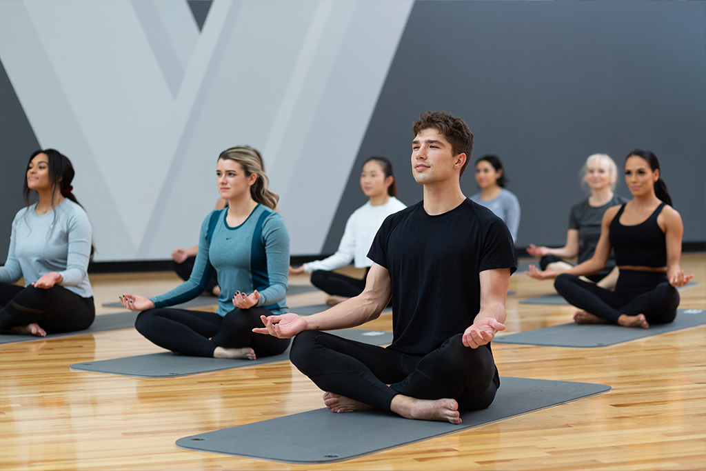 a group of people at a Vasa gym, enjoying the end of their yoga session