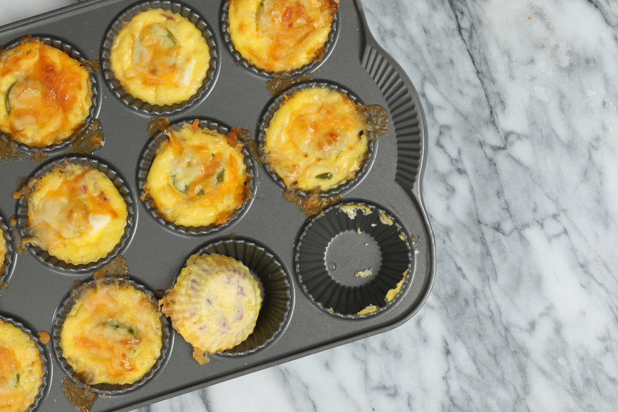 Mini Muffin-Tin Quiches with Smoked Cheddar and Potato fresh out of the oven