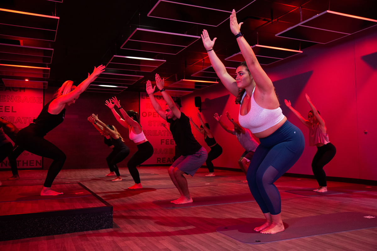 A group of people doing yoga in a vasa studio to reduce holiday stress