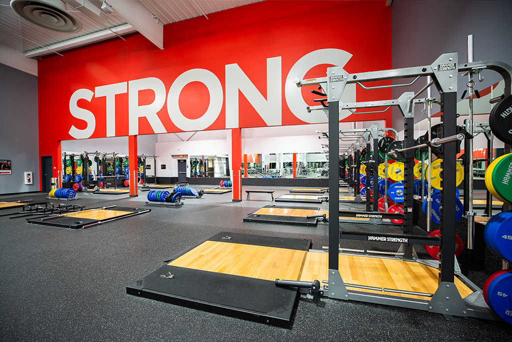 the Vasa Gym free weight area with STRONG written on the back wall.