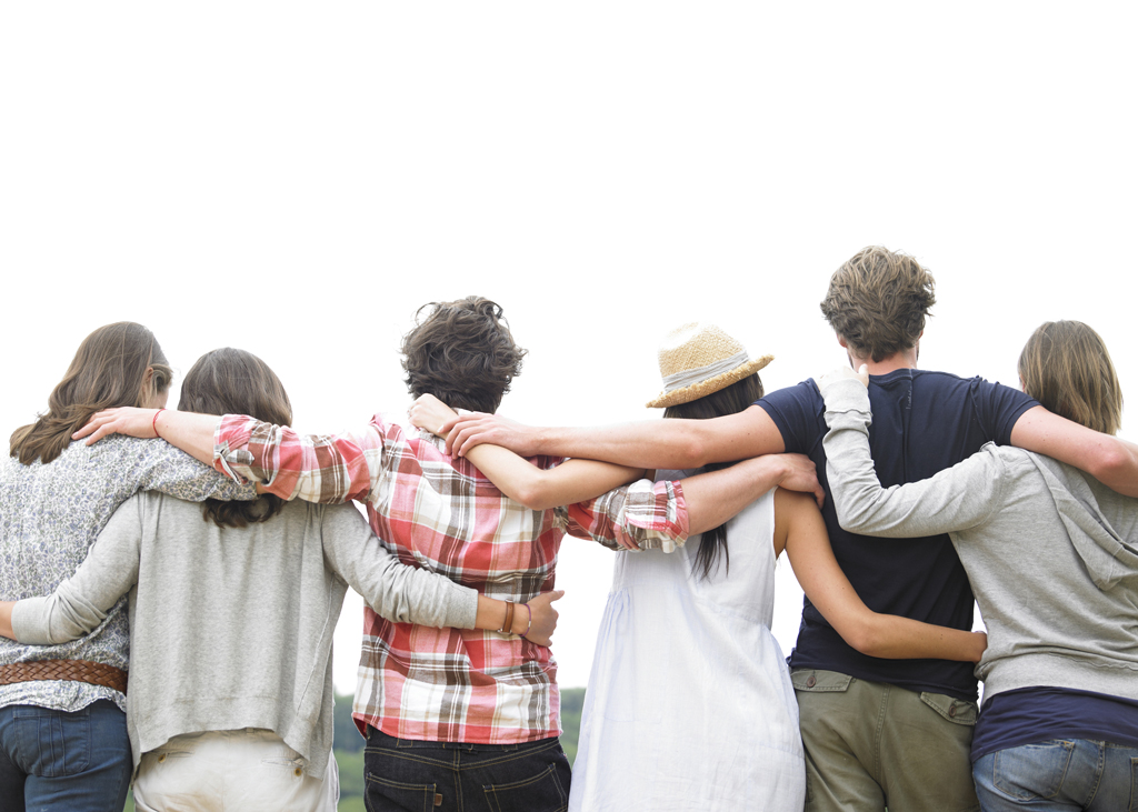 A group of friends with their arms around each other standing in a line