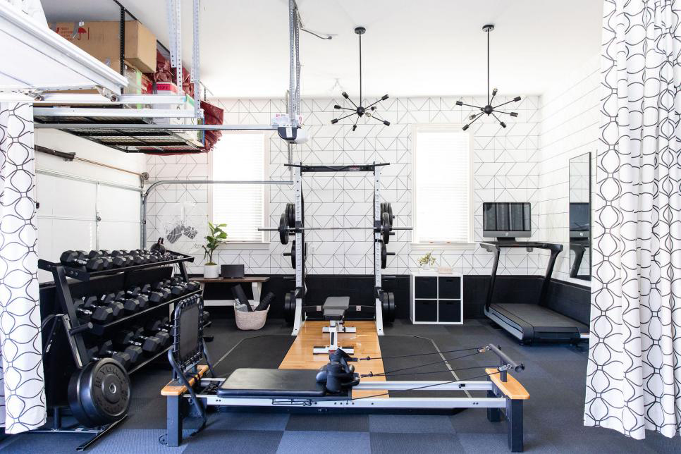 Workout equipment set up in the garage of a home.