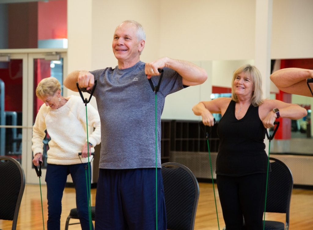 A group of seniors working out at a VASA gym, enjoying the benefits of working out with bands.