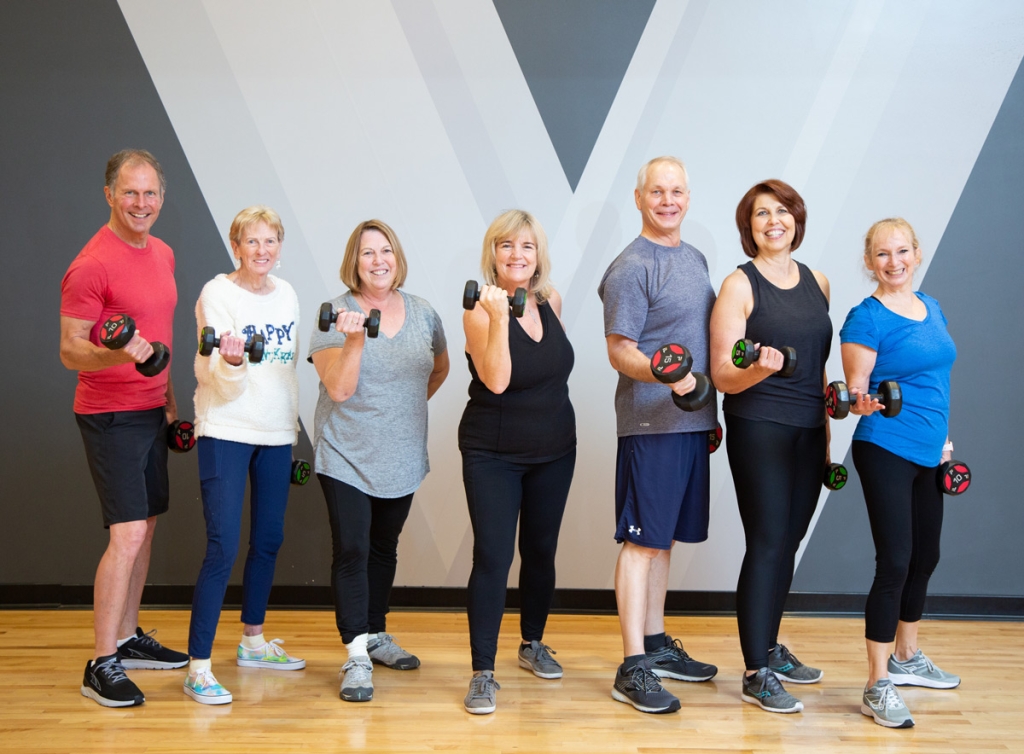 Nine Seniors standing in a line together after working out at their personal training session at VASA