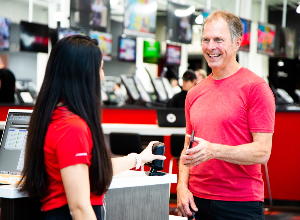 A senior man checking into a VASA gym to workout