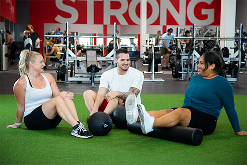 3 people doing active recovery after a workout
