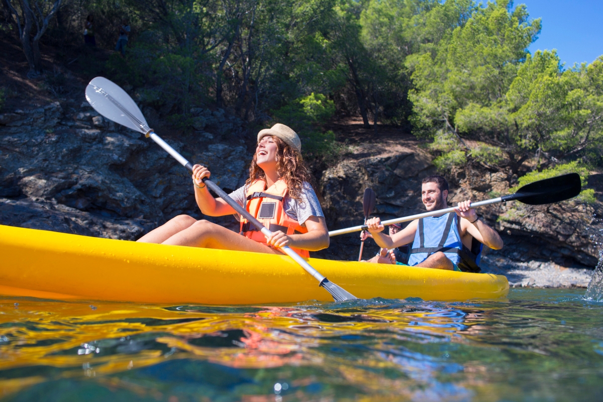 5 Tips for Staying Active on Vacation. Husband and wife kayaking together
