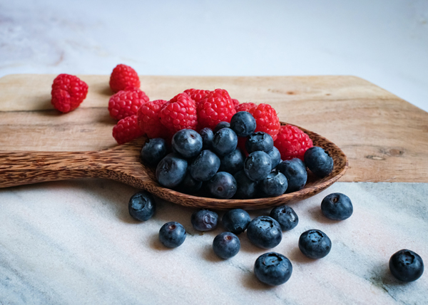 Two Mood-Boosting Smoothies, fresh Raspberries and blueberries