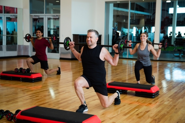 Young and older men and women enjoying a group fitness class