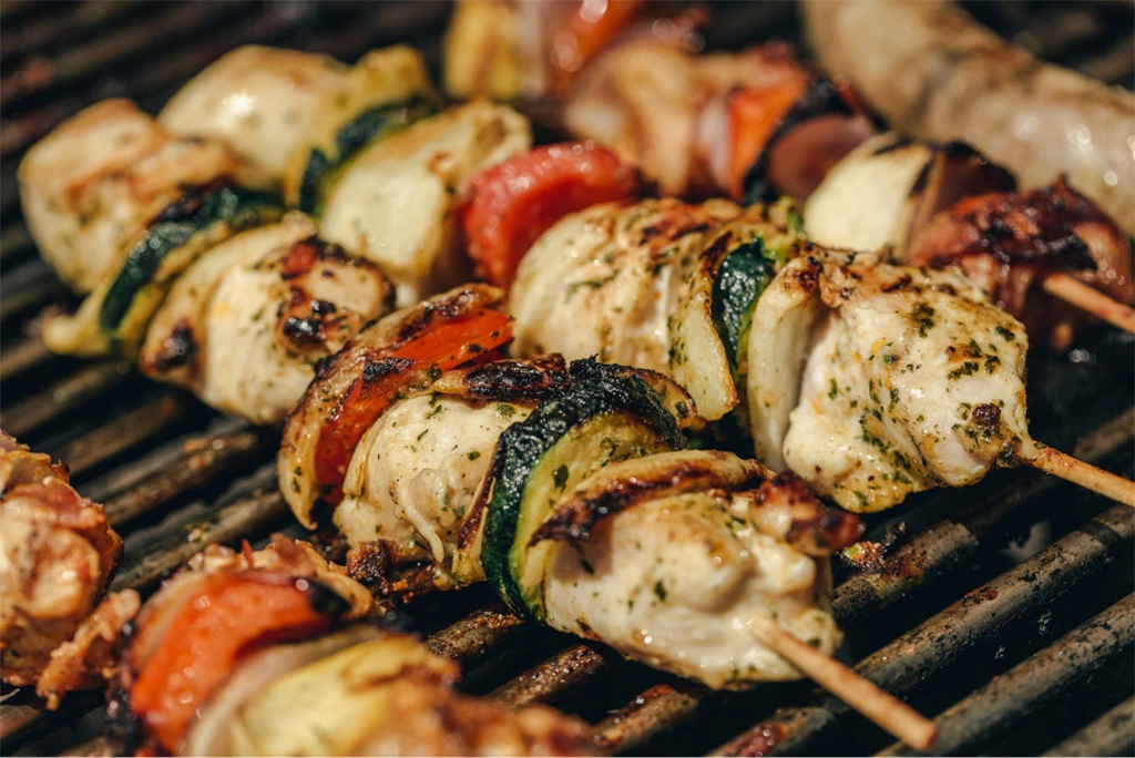 Chicken kebabs with vegetables on a grill