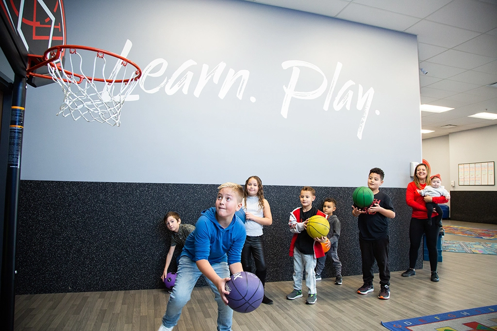 Children playing basketball in VASA Fitness KidCare gym