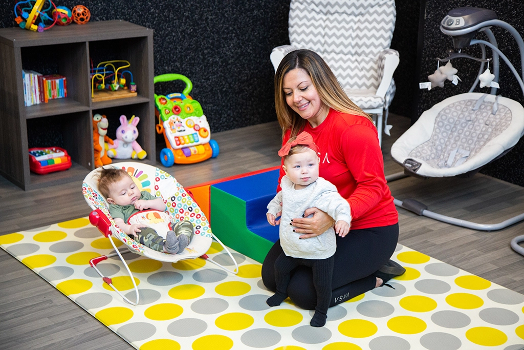 Female VASA employee watching over two babies