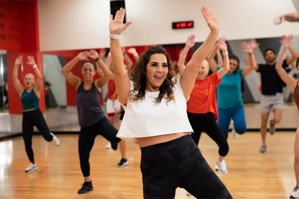 Female athlete dancing in a group fitness class at VASA Fitness