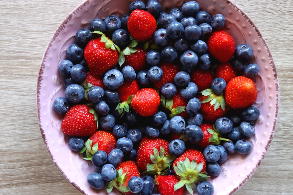 A bowl of fresh strawberries and blueberries