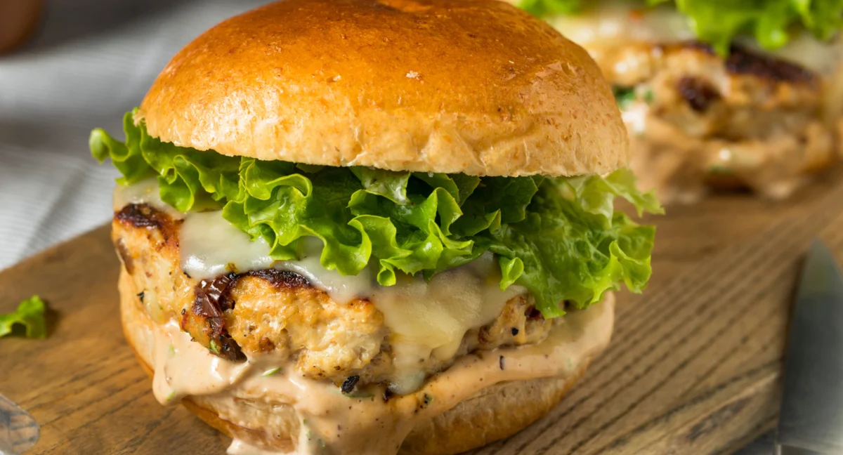 Grilled chicken sandwich with lettuce and sauce