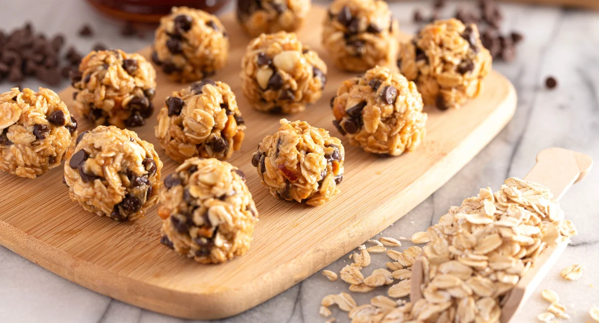 Chocolate peanut butter protein balls on a wooden board.